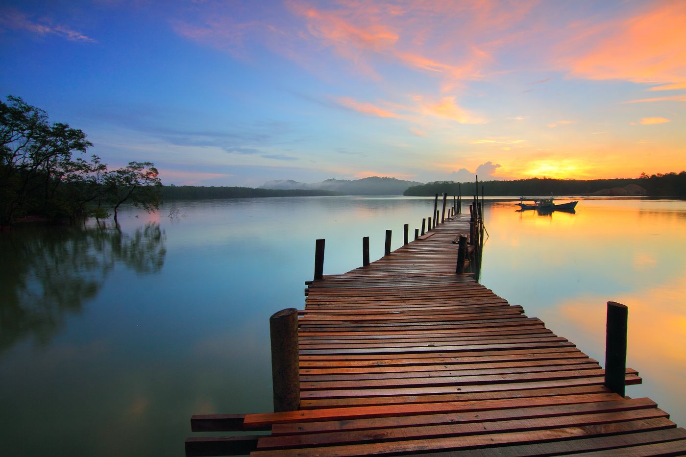 A timber jetty leading towards a calm horizon