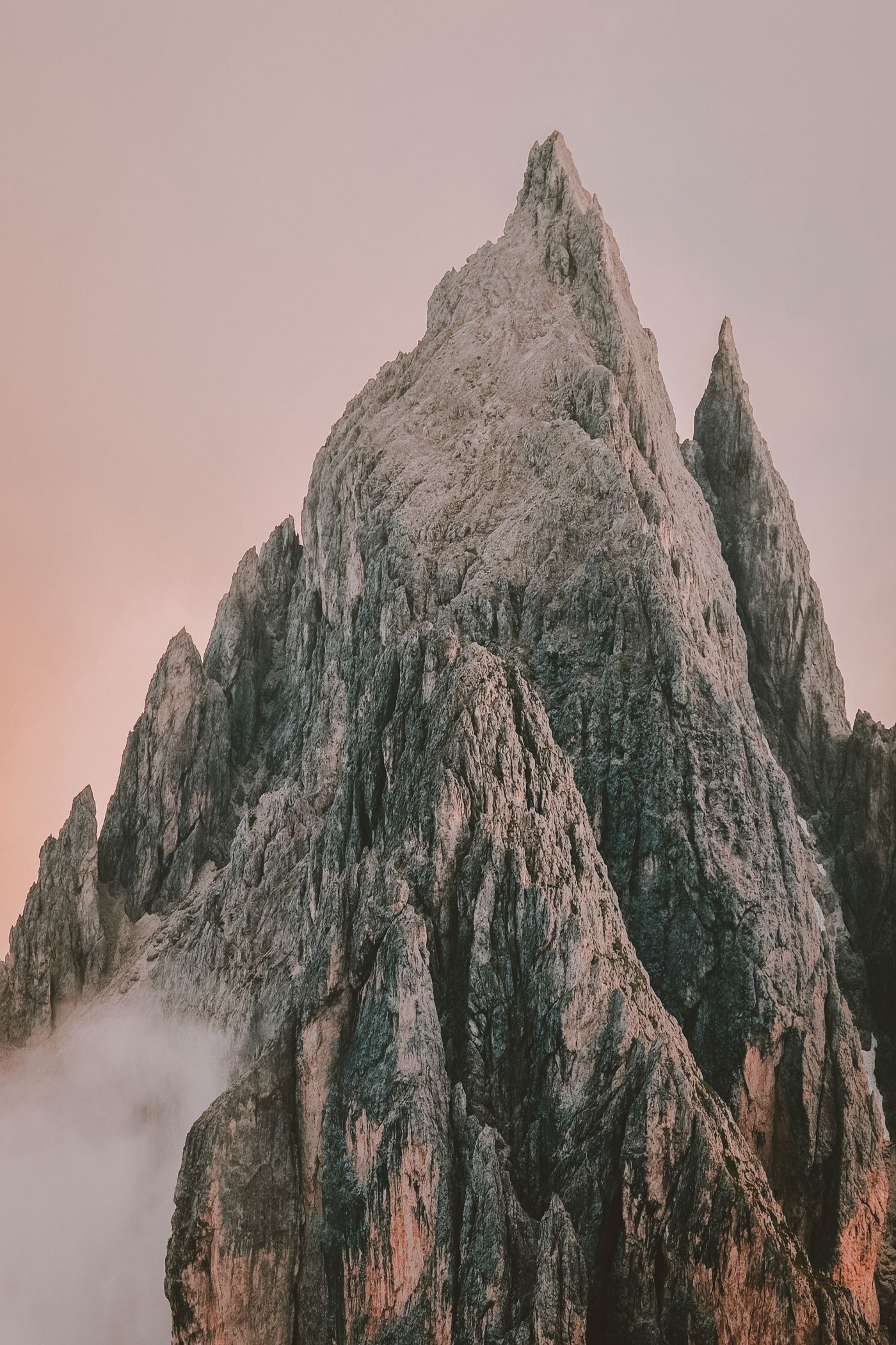 A steep mountain face surrounded by forest