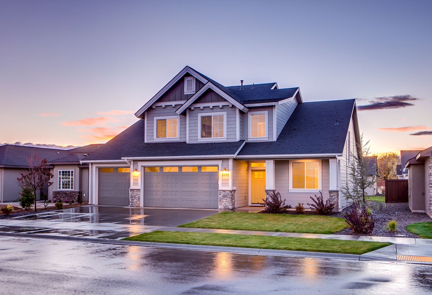 Detached house with an illuminated entrance at sunset