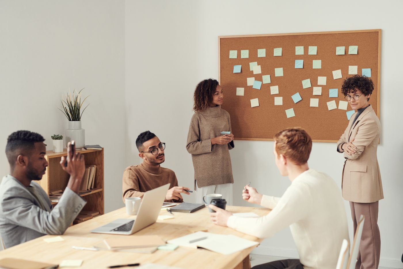 Colleagues considering ideas at a meeting table