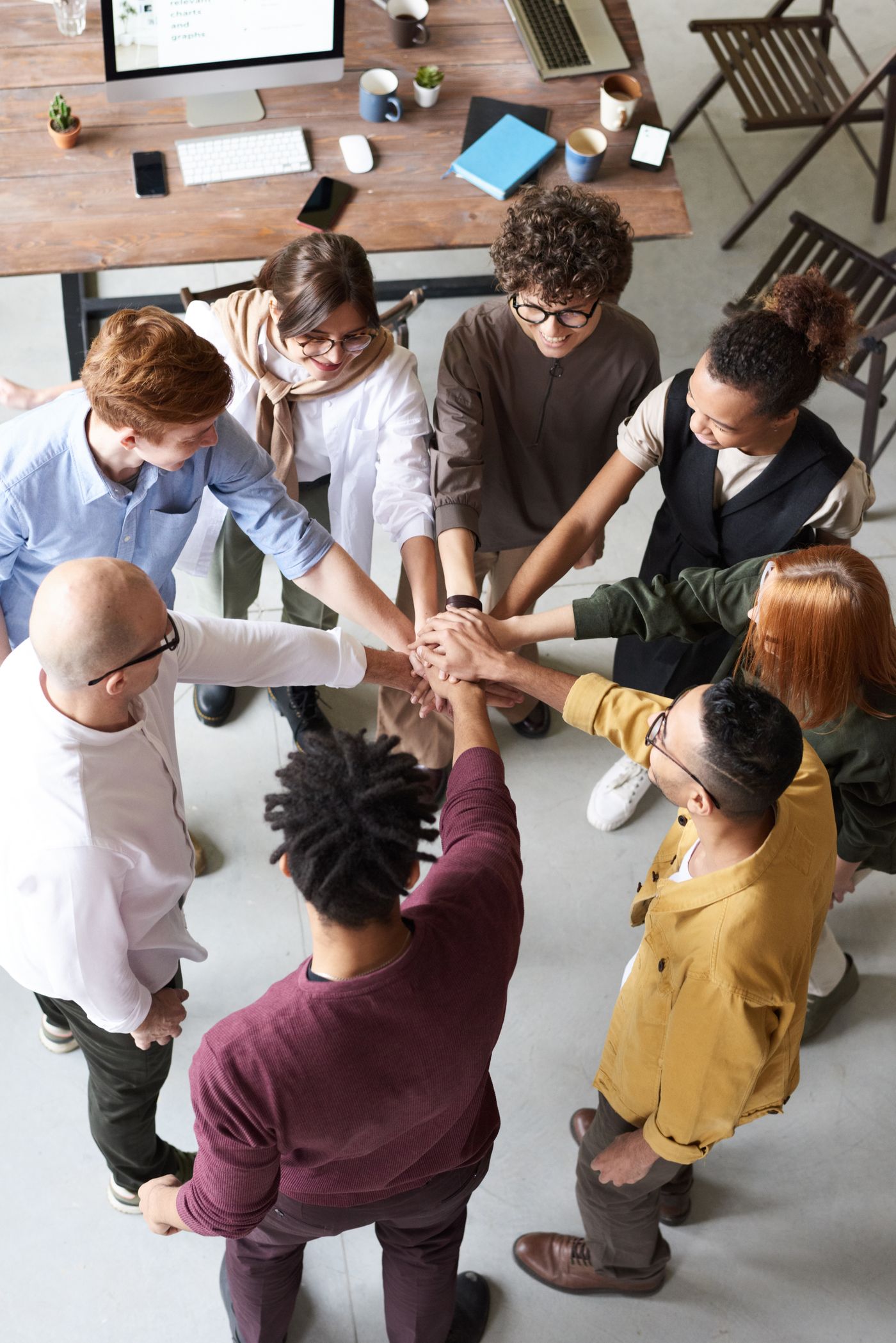 A team joining hands during a collaborative session