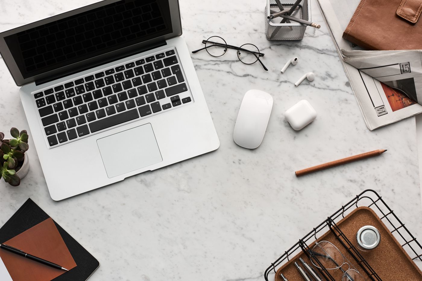 An organised workspace with laptop and planning notes