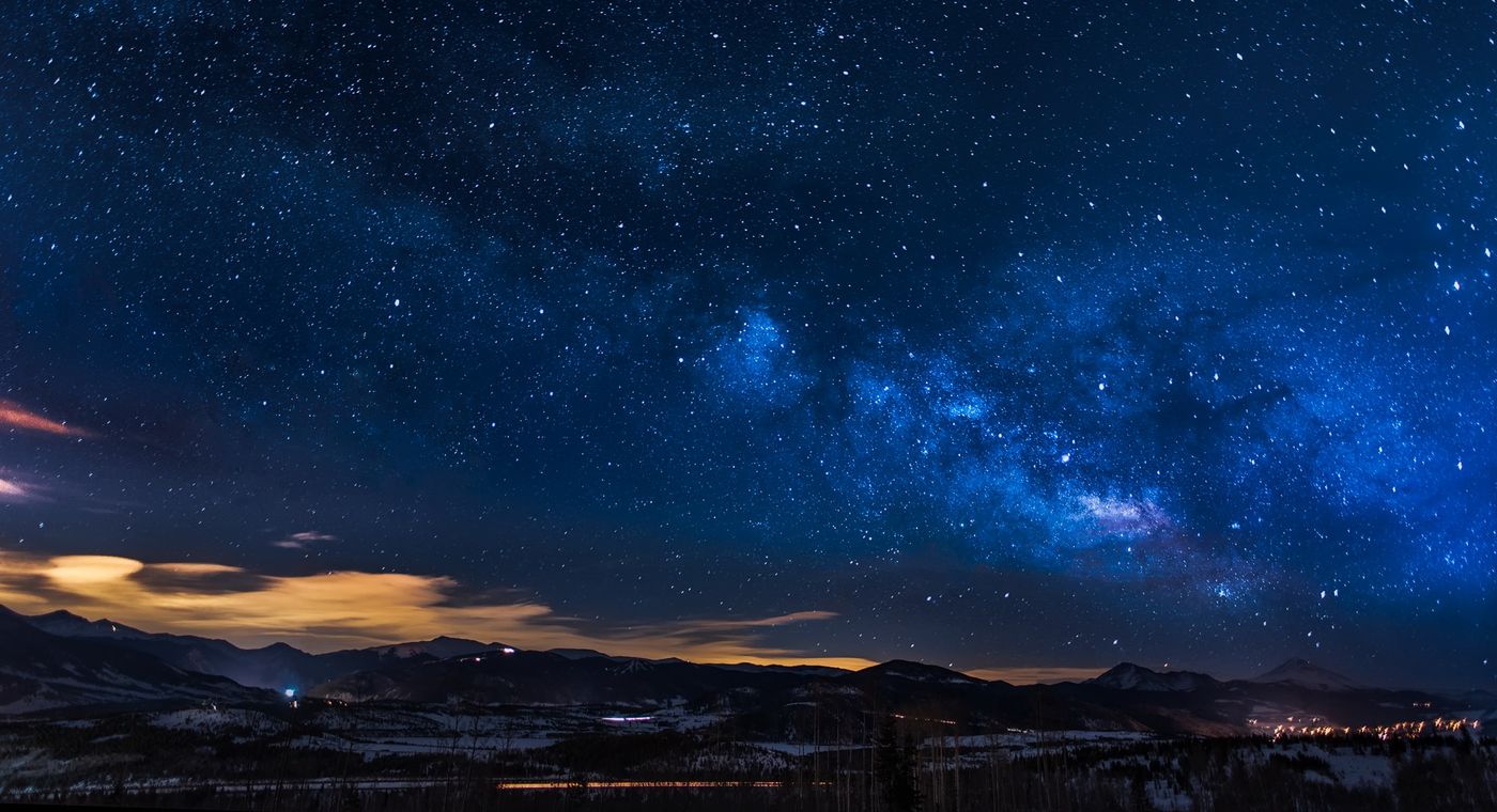An open landscape beneath a star-filled sky