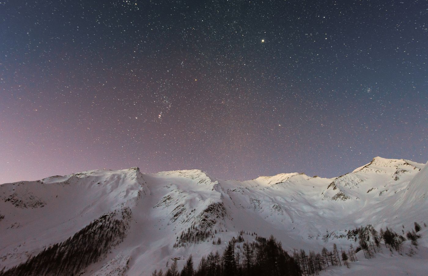 Snowy peaks beneath a quiet night sky
